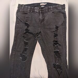 Distressed black skinny jeans